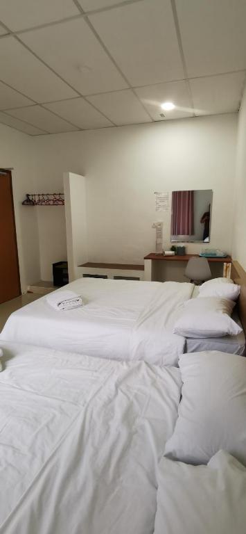 Postel nebo postele na pokoji v ubytování Tang Hotel
