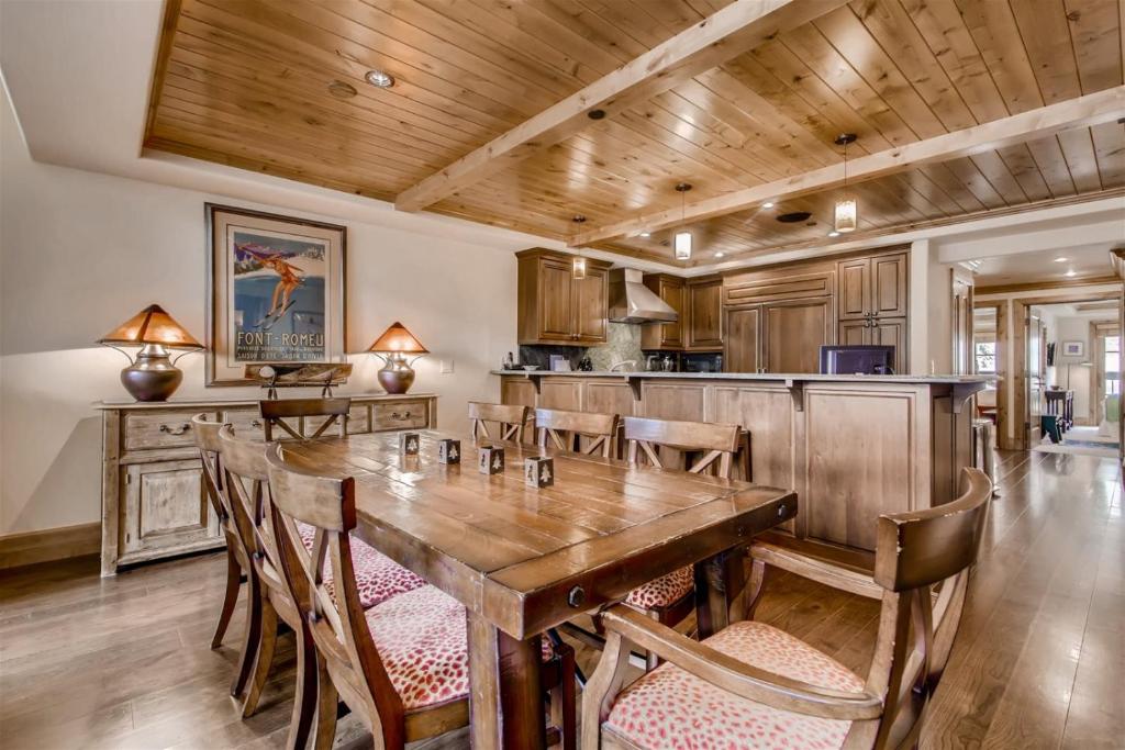 a dining room with a wooden table and chairs at 1-Vail Mountain View 403 in Vail