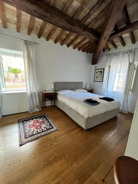 a bedroom with a large bed and a wooden floor at Rome center apt in Rome