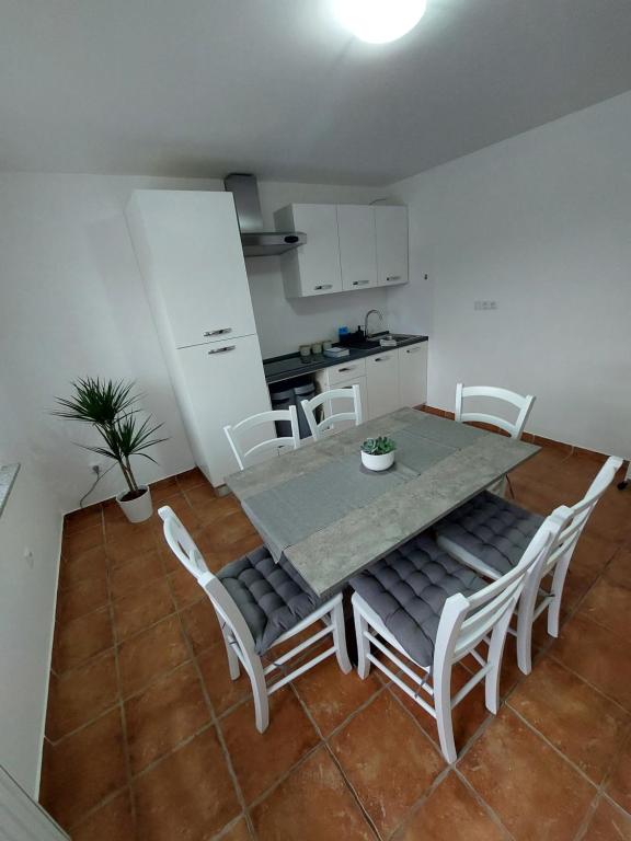 a kitchen with a table and chairs in a room at Apartma Sandi in Šentilj