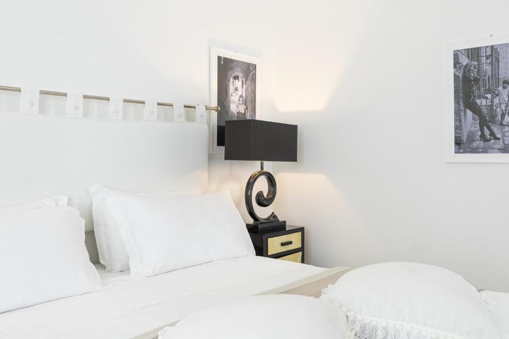 Postel nebo postele na pokoji v ubytování Roccobarocco Boutique Hotel