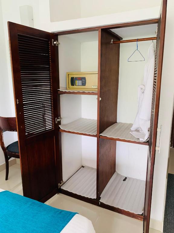 Postel nebo postele na pokoji v ubytování Hotel Gangaaddara