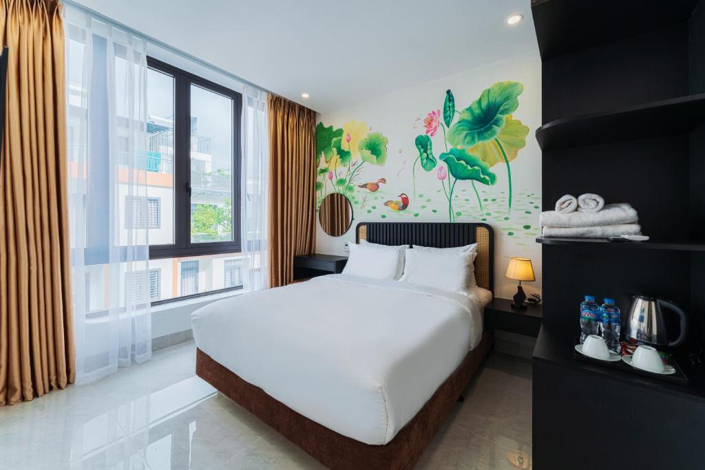 a bedroom with a large bed and a large window at Q Boutique Hotel in Nha Trang