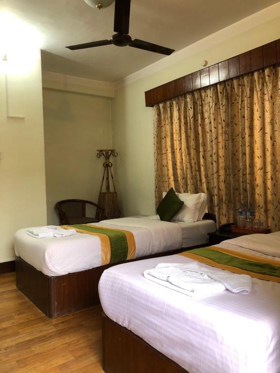 Postel nebo postele na pokoji v ubytování Bouddha Green Hotel