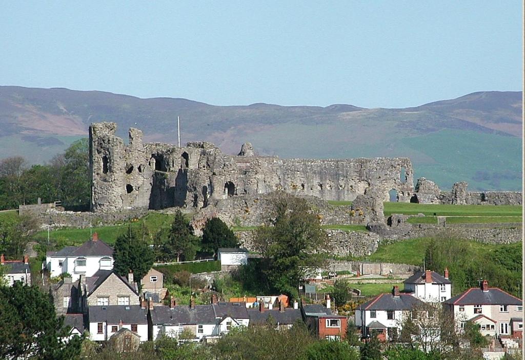 a castle on a hill with houses and buildings at Florence House in Denbigh
