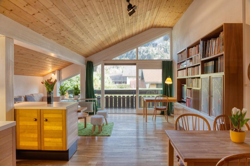 a kitchen and living room with a large window at Ruhige Ferienwohnungen in Partenkirchen 1 in Garmisch-Partenkirchen