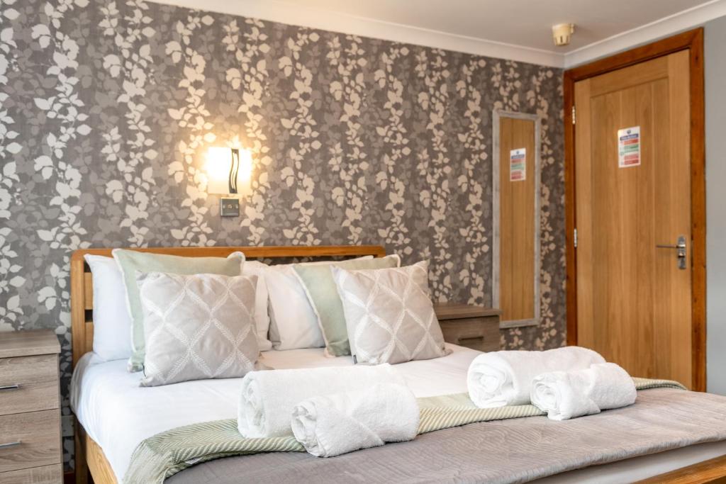 Ένα ή περισσότερα κρεβάτια σε δωμάτιο στο The New Lodge