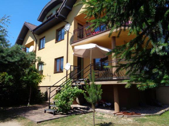 un gran edificio amarillo con balcón y escaleras en Garden Apartment, en Oborniki Śląskie