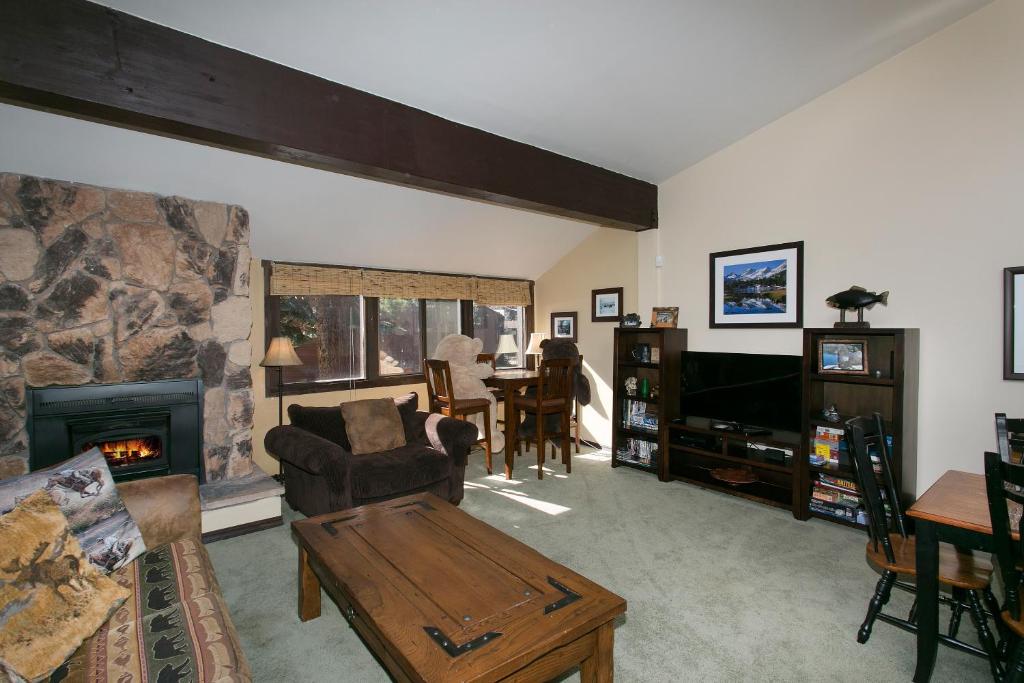 a living room with a couch and a fireplace at Mammoth Village Properties by 101 Great Escapes in Mammoth Lakes