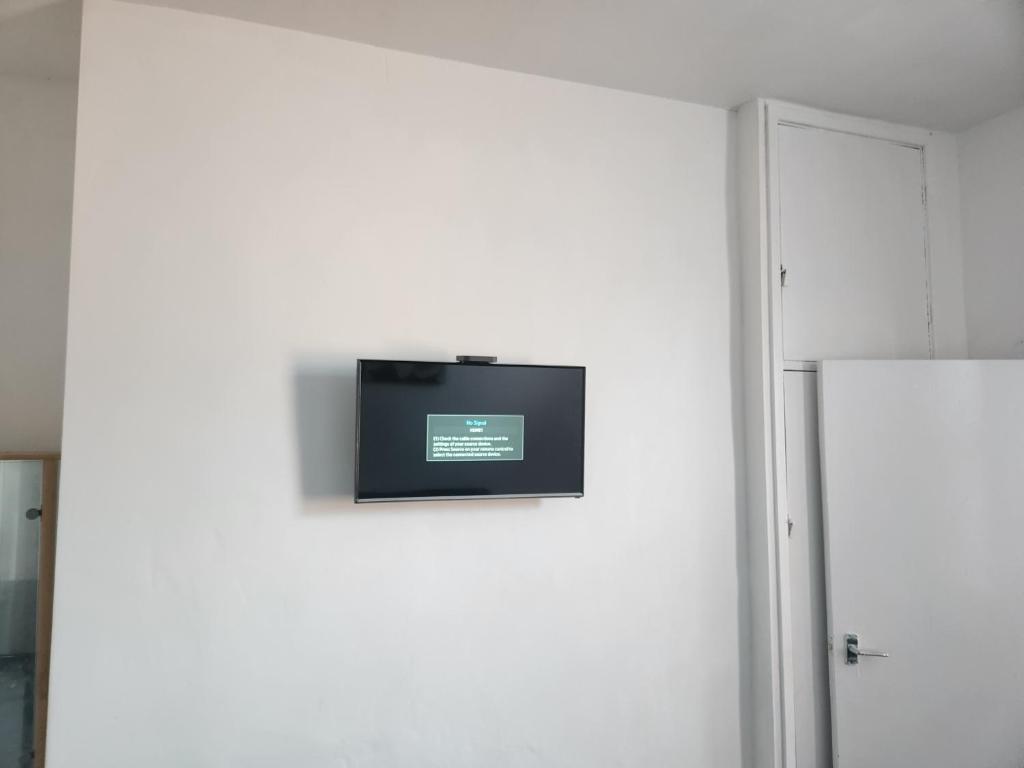 a flat screen tv on a white wall in a room at Long Stay, Contractors, Stags & Hens in Elswick