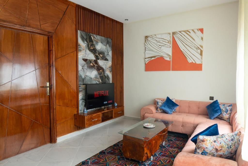 a living room with a couch and a tv at Imlil apartment in Azrou