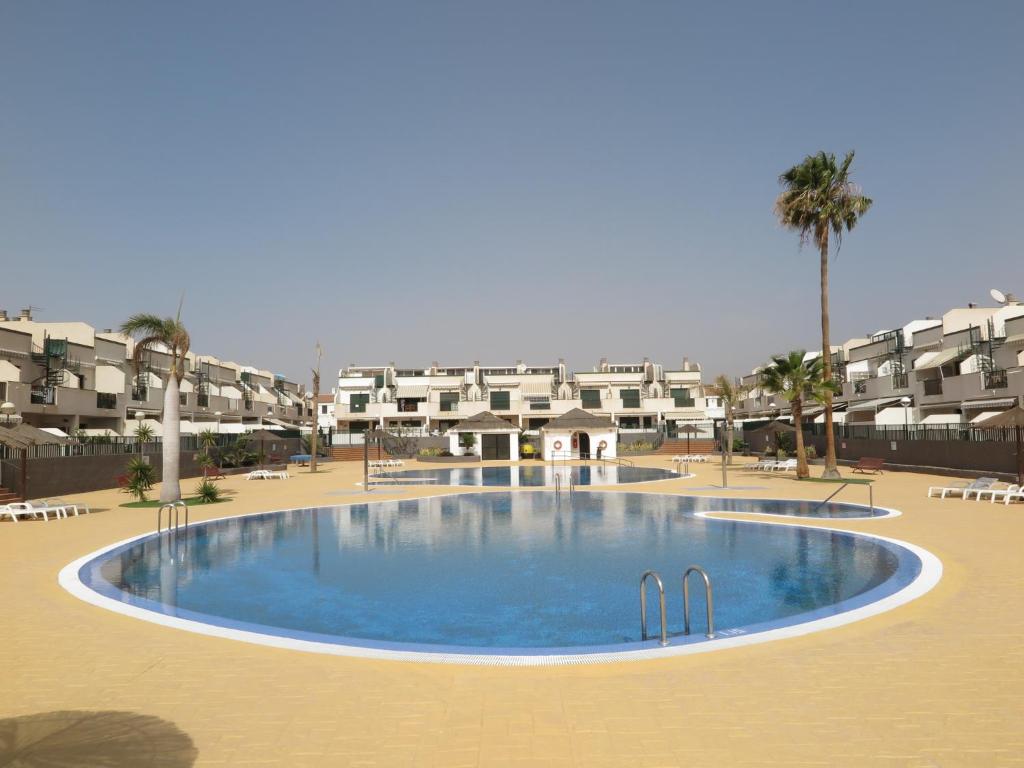 a large swimming pool in the middle of a resort at Los Geranios 21 Tenerife in Costa Del Silencio