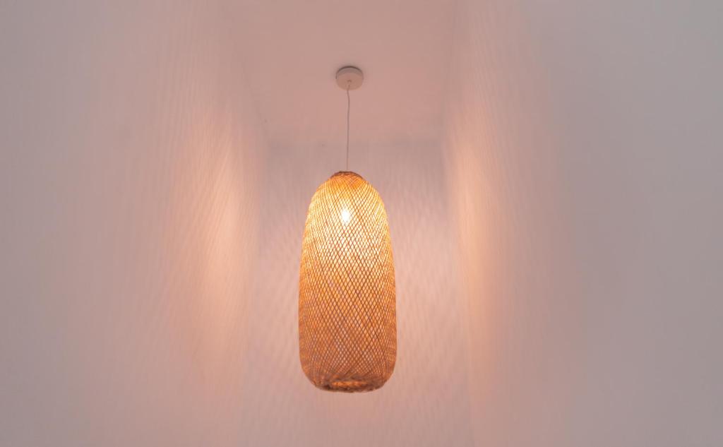 a pendant light hanging from a wall at La Casa Turquesa in Águilas
