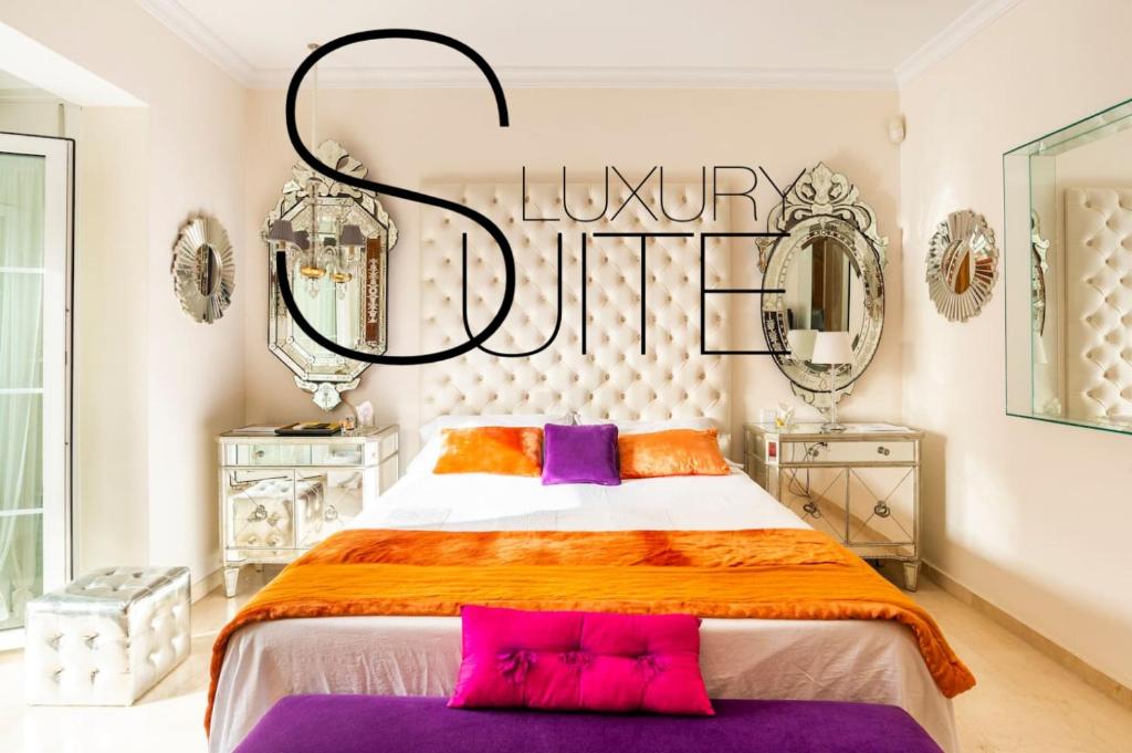 a bedroom with a large bed with a sign that reads runway plus at Z&Olé in Torremolinos