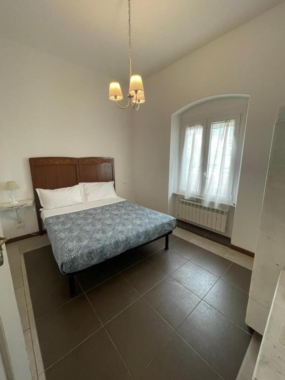 Schlafzimmer mit einem Bett und einem Kronleuchter in der Unterkunft Trainspot Apartment in La Spezia