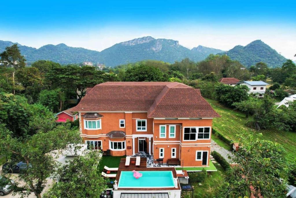 an aerial view of a house with a swimming pool at Chateau de Luxi Khao Yai - ชาโตว์ เดอ ลูซี่ เขาใหญ่ in Mu Si