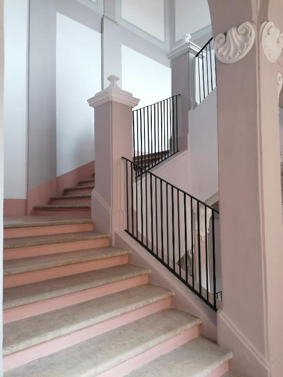 a staircase in a home with pink and white walls at MA Hotel in Corinaldo