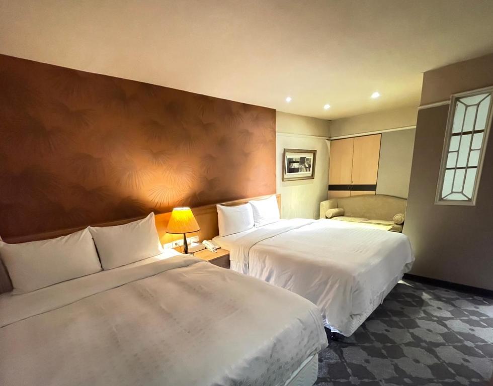 Postel nebo postele na pokoji v ubytování Dahshin Hotel