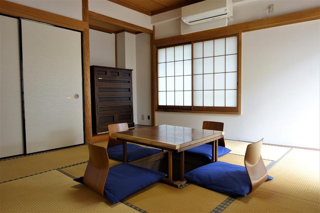 a dining room with a wooden table and chairs at Condo within Tokyo DisneyResort 10 people can stay in Tokyo