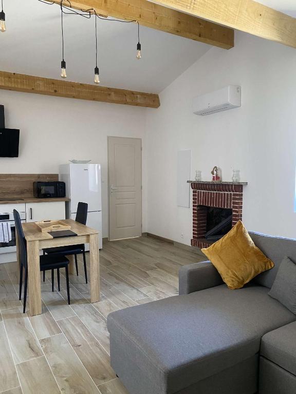 a living room with a couch and a table at Bel appartement au coeur du village de Sartene in Sartène