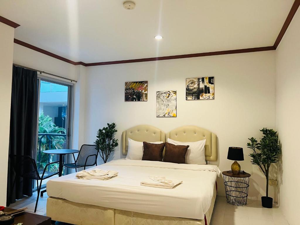 Postel nebo postele na pokoji v ubytování Cocoon Omaya Guest House