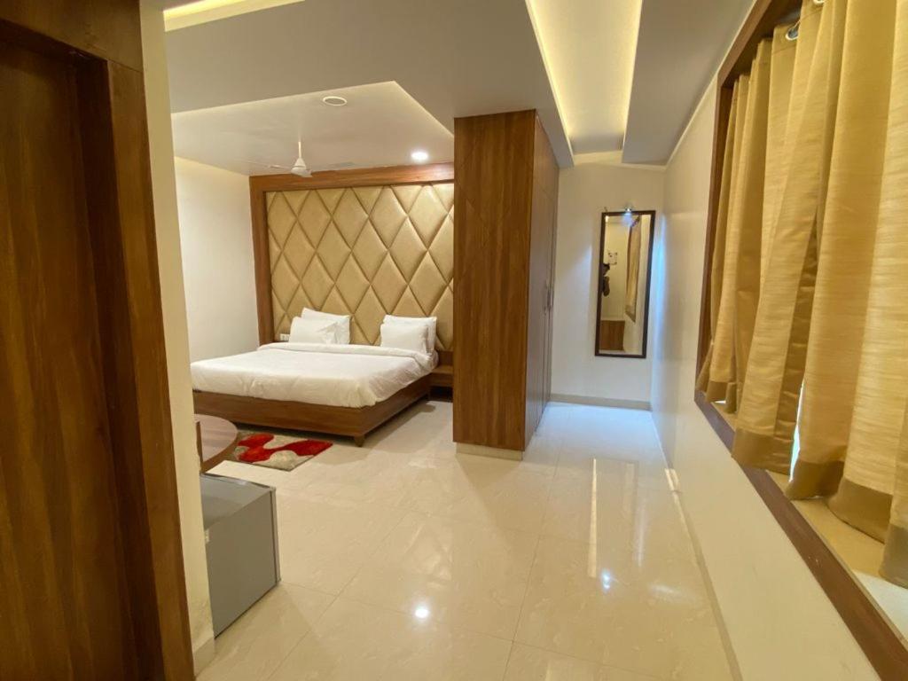 a hotel room with a bed and a room with at Hotel Pradeep Star Inn in Gorakhpur