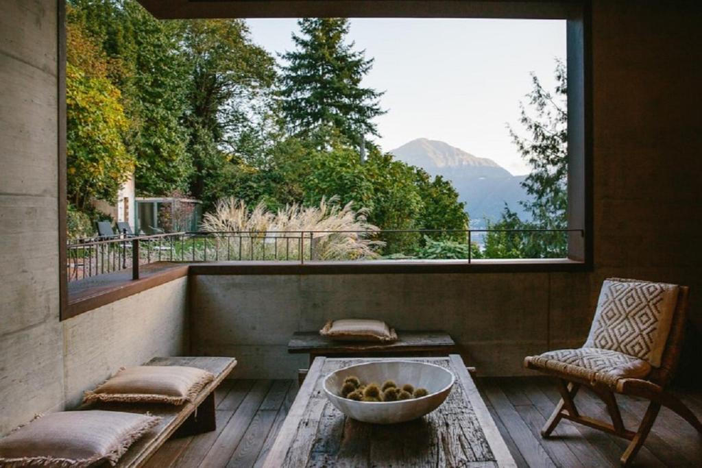 a balcony with a bowl of fruit on a table at Relais Castello di Morcote in Morcote