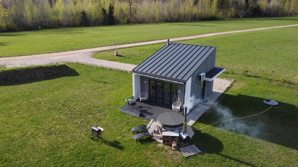 an overhead view of a tiny house in a field at OH DEER holiday house in Veismaņi