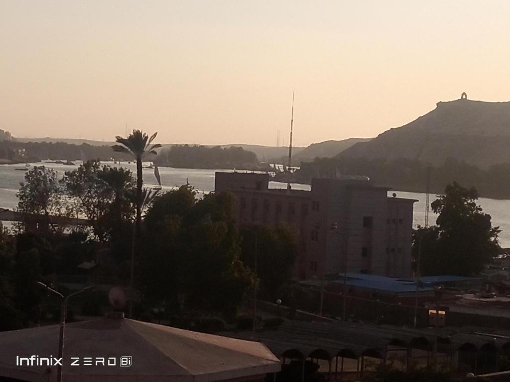 a view of a body of water with a building at Aswan Nile view palace in Naj‘ al ‘Amrāb