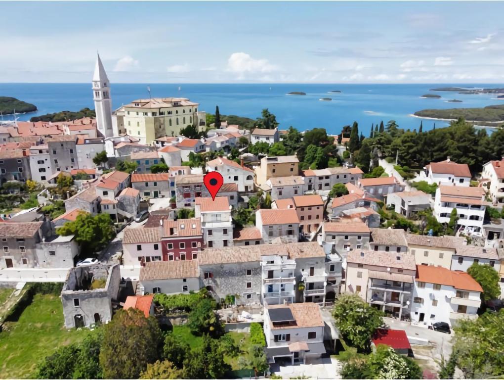 a town with a red marker on top of it at Art Apartments Vrsar in Vrsar