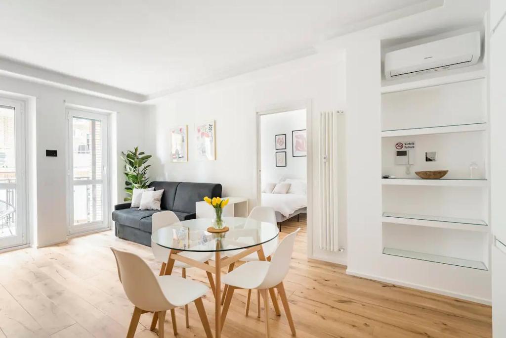 a living room with a table and chairs and a couch at Trastevere Boutique Apartment in Rome