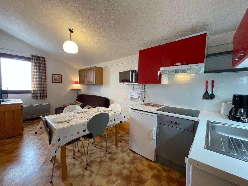 a kitchen with a table and a small kitchen with a dining room at Appartement Samoëns, 2 pièces, 6 personnes - FR-1-624-79 in Samoëns