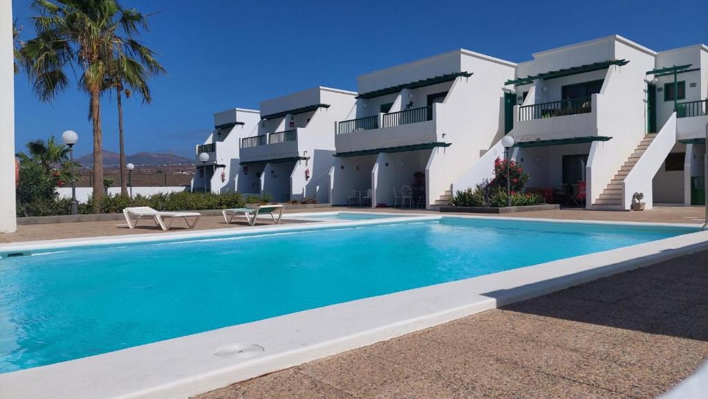 a swimming pool in front of a building at Casa Julia in Tías