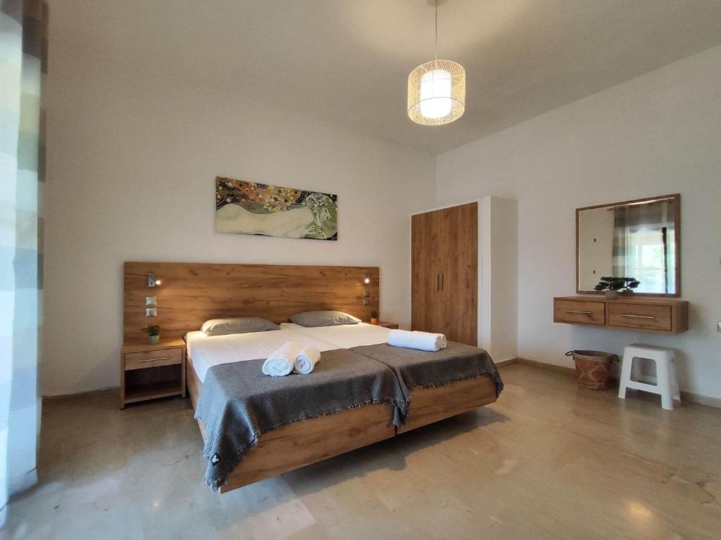 a bedroom with a large bed with two towels on it at Tony's Garden House in Lefkimmi