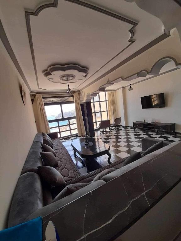 a large living room with a couch and a table at Al-marsa2 in Al Hoceïma