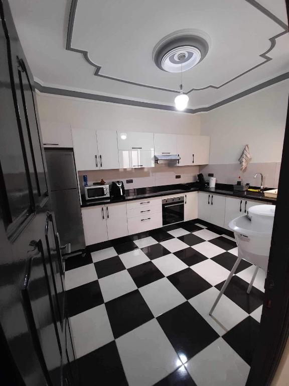 a kitchen with a black and white checkered floor at Al-marsa2 in Al Hoceïma