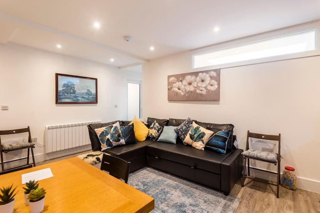 a living room with a couch and a table at Comfortable flat close to the beach in Brighton & Hove