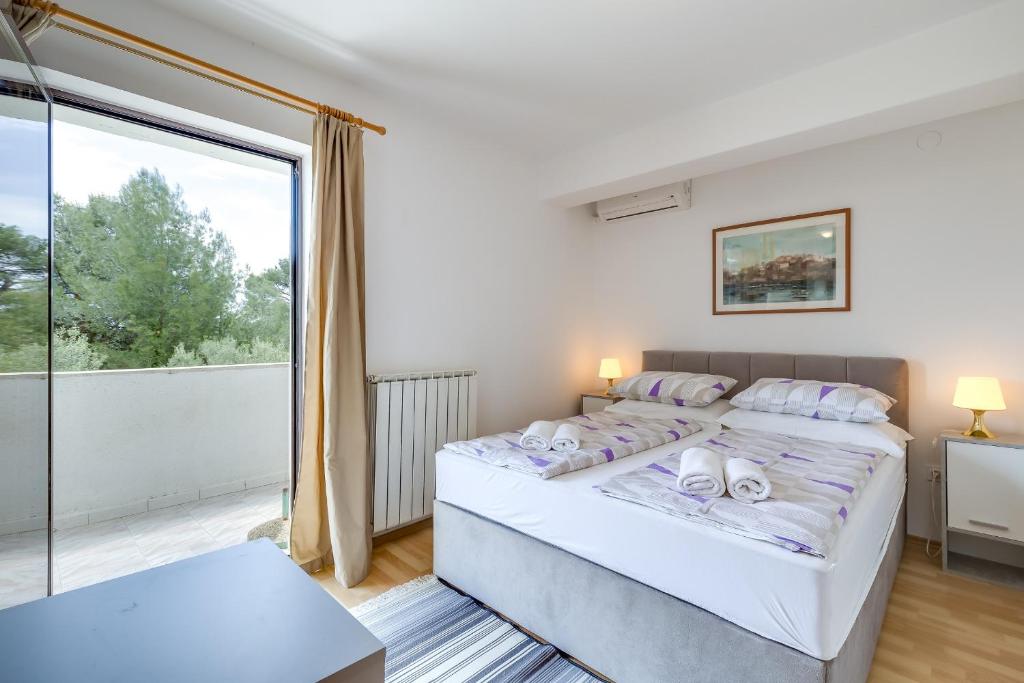 Postel nebo postele na pokoji v ubytování Apartments Dado