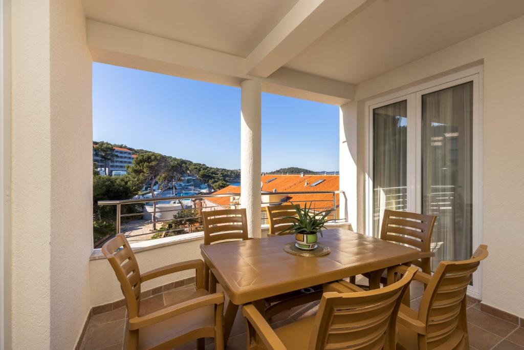 a dining room with a table and chairs on a balcony at Sanpier Apartments in Veli Lošinj
