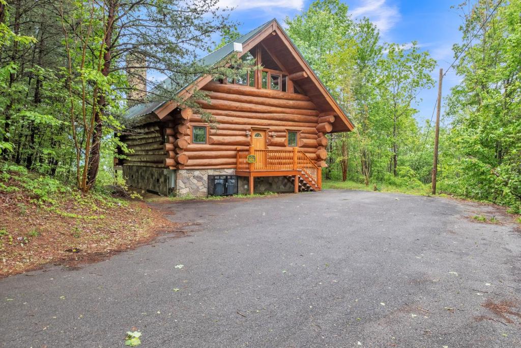 a log cabin in the woods with a driveway at Royal Views - Private Mountain Top Cabin cabin in Gatlinburg