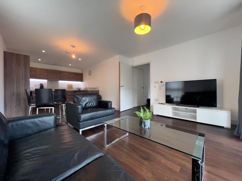 a living room with a couch and a glass table at Modern 2BR 2BA Apt wParking Sleeps 6 Comfortably in London