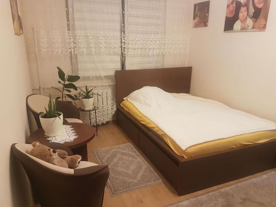 a bedroom with a bed and a chair and a table at Topolowa 13 in Mińsk Mazowiecki