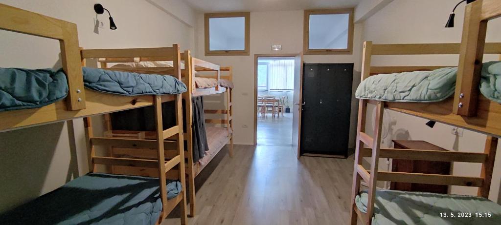 a room with four bunk beds and a hallway at PRENOČIŠČE 9a in Tolmin