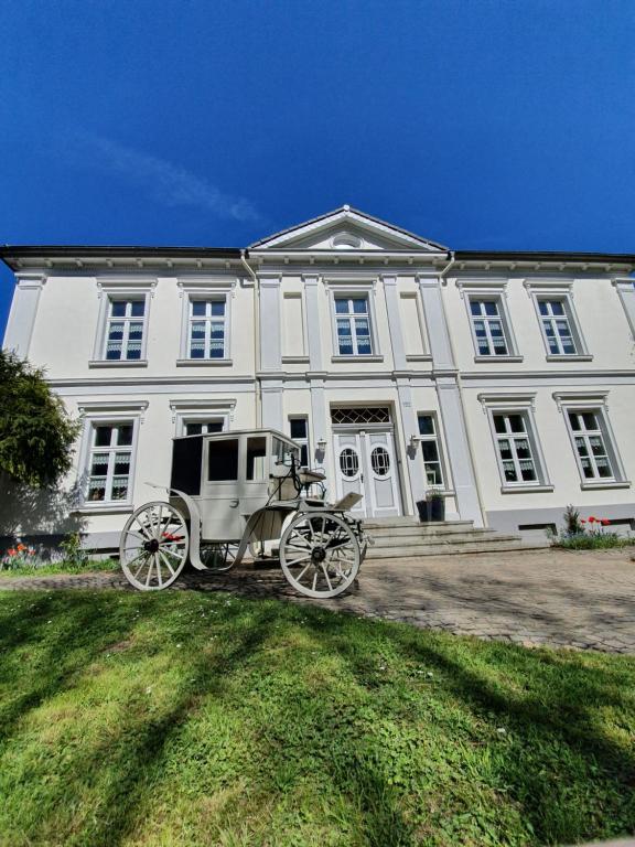 a carriage parked in front of a white building at Haus Husen in Xanten