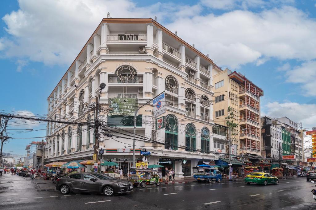 a building on a busy city street with cars at Exoresidence The Heart of Chinatown in Bangkok