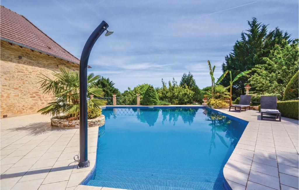 a swimming pool with a light pole next to a house at Stunning Home In Terrasspn-lavilledieu With 3 Bedrooms, Wifi And Outdoor Swimming Pool in Bouillac