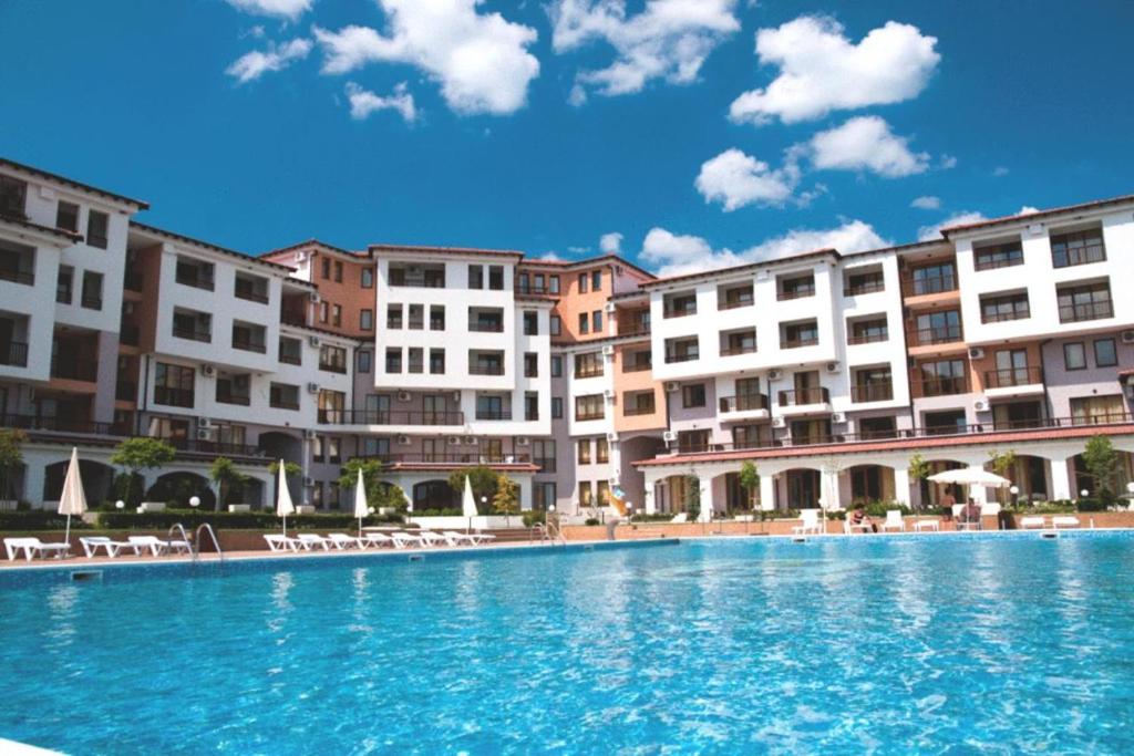 a large swimming pool in front of some buildings at Apartments in complex Harmony hills in Rogachevo