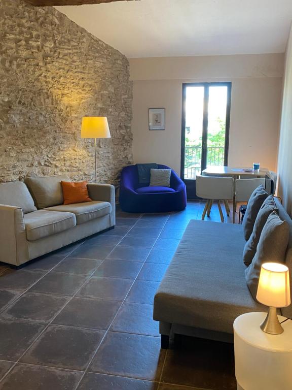 a living room with a couch and a table at 13 QUAI JEAN JAURES in LʼIsle-sur-la-Sorgue