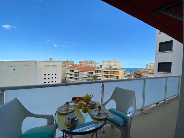 une table et des chaises sur un balcon avec vue dans l'établissement Helios Canet Plage Sea View, à Canet
