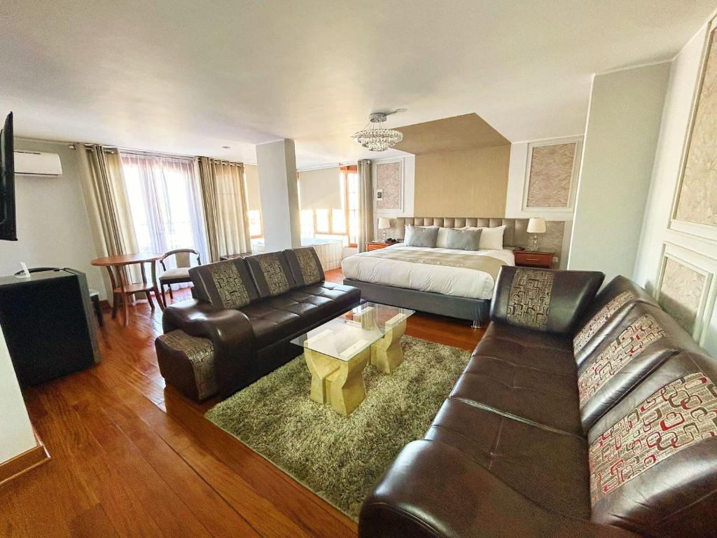 a large living room with a bed and a couch at Hotel Fundador in Arequipa